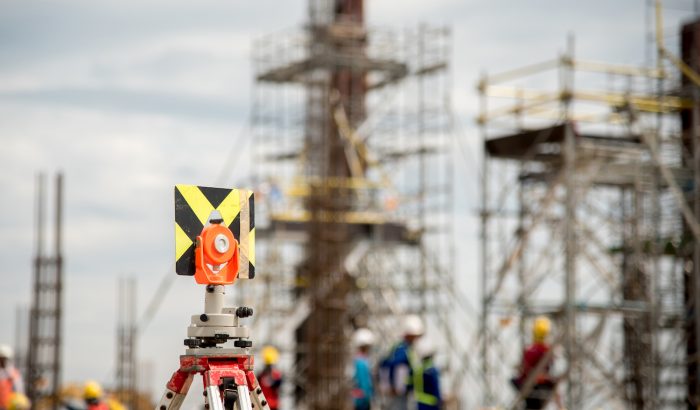 Survey instrument set on a tripod in construction site